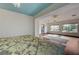Shot of a bedroom with hardwood floors and natural light beaming in through the large windows at 10519 Bella Camrosa Dr, Las Vegas, NV 89141