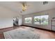 Large bedroom featuring hardwood floors, large windows, and an ensuite bathroom at 10519 Bella Camrosa Dr, Las Vegas, NV 89141