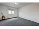 A large bedroom with a guitar and stand situated in the corner of the room at 10519 Bella Camrosa Dr, Las Vegas, NV 89141