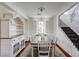 Charming dining room with a farmhouse-style table, white chairs, and decorative hutch at 10519 Bella Camrosa Dr, Las Vegas, NV 89141