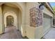 Inviting entryway featuring tile flooring, archways, and stone accents at 10519 Bella Camrosa Dr, Las Vegas, NV 89141