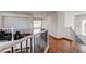 Bright hallway featuring hardwood floors and decorative stair railing with view to other rooms at 10519 Bella Camrosa Dr, Las Vegas, NV 89141
