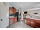 Modern kitchen area flowing into living room, stainless steel refrigerator, granite counters at 10519 Bella Camrosa Dr, Las Vegas, NV 89141