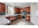Well-lit kitchen with wood cabinets, stainless steel appliances, and granite countertops at 10519 Bella Camrosa Dr, Las Vegas, NV 89141
