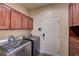 Well-equipped laundry room with a washer, dryer, and ample storage cabinetry at 10519 Bella Camrosa Dr, Las Vegas, NV 89141