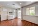 Bright living room with hardwood floors, modern fireplace, and sliding glass doors to outdoor area at 10519 Bella Camrosa Dr, Las Vegas, NV 89141