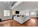 Spacious living room with hardwood floors, a fireplace, and large windows providing ample natural light at 10519 Bella Camrosa Dr, Las Vegas, NV 89141