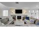 Bright living room featuring a fireplace, media center, and an open floor plan at 10519 Bella Camrosa Dr, Las Vegas, NV 89141