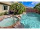 Relax and unwind in your own backyard oasis, featuring a sparkling pool, spa, and lush tropical landscaping at 10519 Bella Camrosa Dr, Las Vegas, NV 89141