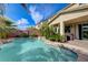 An inviting pool and spa surrounded by mature landscaping, perfect for relaxing outdoors at 10519 Bella Camrosa Dr, Las Vegas, NV 89141