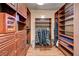 Spacious walk-in closet with custom built-in shelving, drawers, and hanging rods for optimal storage at 10519 Bella Camrosa Dr, Las Vegas, NV 89141