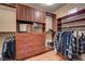Spacious walk-in closet with custom built-in shelving, drawers, and hanging rods for optimal storage at 10519 Bella Camrosa Dr, Las Vegas, NV 89141