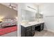 Beautiful bathroom featuring dual sinks and a large mirror at 1084 Little House Ct, Henderson, NV 89011
