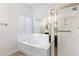 Bright bathroom featuring a soaking tub and a separate glass-enclosed shower at 1084 Little House Ct, Henderson, NV 89011