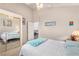 Bright bedroom featuring carpet flooring, mirrored closet doors, and adjacent bathroom at 1084 Little House Ct, Henderson, NV 89011