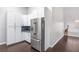 Modern kitchen with stainless steel refrigerator and white cabinetry at 1084 Little House Ct, Henderson, NV 89011