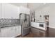 Modern kitchen featuring stainless steel appliances and sleek white cabinetry at 1084 Little House Ct, Henderson, NV 89011
