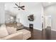 Bright living room with hardwood floors, a fireplace, and a comfortable sectional sofa at 1084 Little House Ct, Henderson, NV 89011
