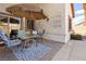 Cozy patio area with a round table, chairs, and sun umbrella, perfect for outdoor dining at 1084 Little House Ct, Henderson, NV 89011