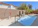 Inviting backyard pool with waterfall feature, desert landscaping, and a serene ambiance at 1084 Little House Ct, Henderson, NV 89011