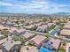 Expansive aerial of a community featuring rooftops, tree-lined streets, and mountain views at 10886 Porto Foxi St, Las Vegas, NV 89141