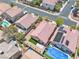 Aerial shot of residential homes featuring pools, manicured yards, and solar panels at 10886 Porto Foxi St, Las Vegas, NV 89141