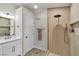 Bathroom featuring white cabinets, modern fixtures, and glass shower with a rainfall showerhead at 10886 Porto Foxi St, Las Vegas, NV 89141