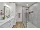 Bathroom features a walk-in shower with glass doors, dual sinks, and modern fixtures at 10886 Porto Foxi St, Las Vegas, NV 89141