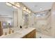 Elegant bathroom with double sinks, gold fixtures, and a stunning marble-tiled shower with built-in niche at 10886 Porto Foxi St, Las Vegas, NV 89141