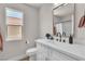 Bathroom featuring a single sink, wood-look floors, and window to the exterior at 10886 Porto Foxi St, Las Vegas, NV 89141