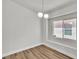 Cozy bedroom featuring wood flooring, a window letting in natural light, and neutral paint at 10886 Porto Foxi St, Las Vegas, NV 89141