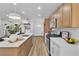 Modern kitchen with stainless steel appliances, an island with seating, and contemporary light fixtures at 10886 Porto Foxi St, Las Vegas, NV 89141
