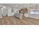 Open kitchen layout featuring an island with bar seating, seamlessly connecting to the living area at 10886 Porto Foxi St, Las Vegas, NV 89141