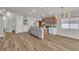 Bright kitchen features an island with seating, modern light fixtures, and stainless steel appliances at 10886 Porto Foxi St, Las Vegas, NV 89141