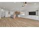 Open living room with recessed lighting, ceiling fan, modern light fixture, and hardwood floors at 10886 Porto Foxi St, Las Vegas, NV 89141