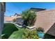 This beautiful backyard features a lush lawn, water feature, and plenty of greenery at 10968 Tracy Stevens Ave, Las Vegas, NV 89166