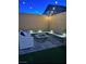 Relaxing backyard with built in seating, fire pit, patio, and string lights at 10968 Tracy Stevens Ave, Las Vegas, NV 89166