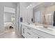 Well-lit bathroom showcasing double sinks, white cabinets, granite countertop, and glass shower door at 10968 Tracy Stevens Ave, Las Vegas, NV 89166