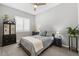 Cozy bedroom with plush carpets, neutral walls, and a large window with natural light at 10968 Tracy Stevens Ave, Las Vegas, NV 89166