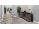 Charming entryway with decorative rustic furniture and natural wood-look flooring at 10968 Tracy Stevens Ave, Las Vegas, NV 89166