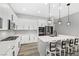 Bright kitchen featuring white cabinets, modern appliances, a gas range, and an island with bar seating at 10968 Tracy Stevens Ave, Las Vegas, NV 89166