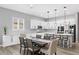 Bright, modern kitchen featuring white cabinets, stainless steel appliances, and a central island with bar seating at 10968 Tracy Stevens Ave, Las Vegas, NV 89166