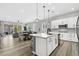 Open-concept kitchen features white cabinets, island seating, and a seamless flow to the dining and living areas at 10968 Tracy Stevens Ave, Las Vegas, NV 89166