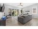 Cozy living room with a sectional sofa, sliding glass doors to the backyard, and neutral decor at 10968 Tracy Stevens Ave, Las Vegas, NV 89166