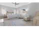 Serene bedroom with a neutral color scheme, decorative rug, plantation shutters, and comfortable seating area at 10968 Tracy Stevens Ave, Las Vegas, NV 89166
