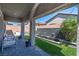 Inviting covered patio boasting pavers, outdoor seating, and a tranquil water feature with turf at 10968 Tracy Stevens Ave, Las Vegas, NV 89166