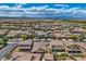 Aerial view showcasing a residential area with desert landscape and houses with terracotta roofs at 1113 Via Della Costrella, Henderson, NV 89011