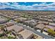 Expansive aerial view of a neighborhood with houses, desert scenery, and mountain range backdrop at 1113 Via Della Costrella, Henderson, NV 89011