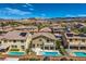 Beautiful aerial view showcasing houses with private pools and a stunning mountain backdrop at 1113 Via Della Costrella, Henderson, NV 89011