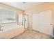 Bright bathroom featuring a soaking tub, shower and closet providing a relaxing space at 1113 Via Della Costrella, Henderson, NV 89011